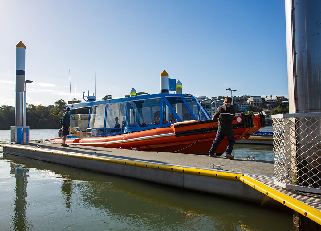 A commercial boat pulling up at a pontoon